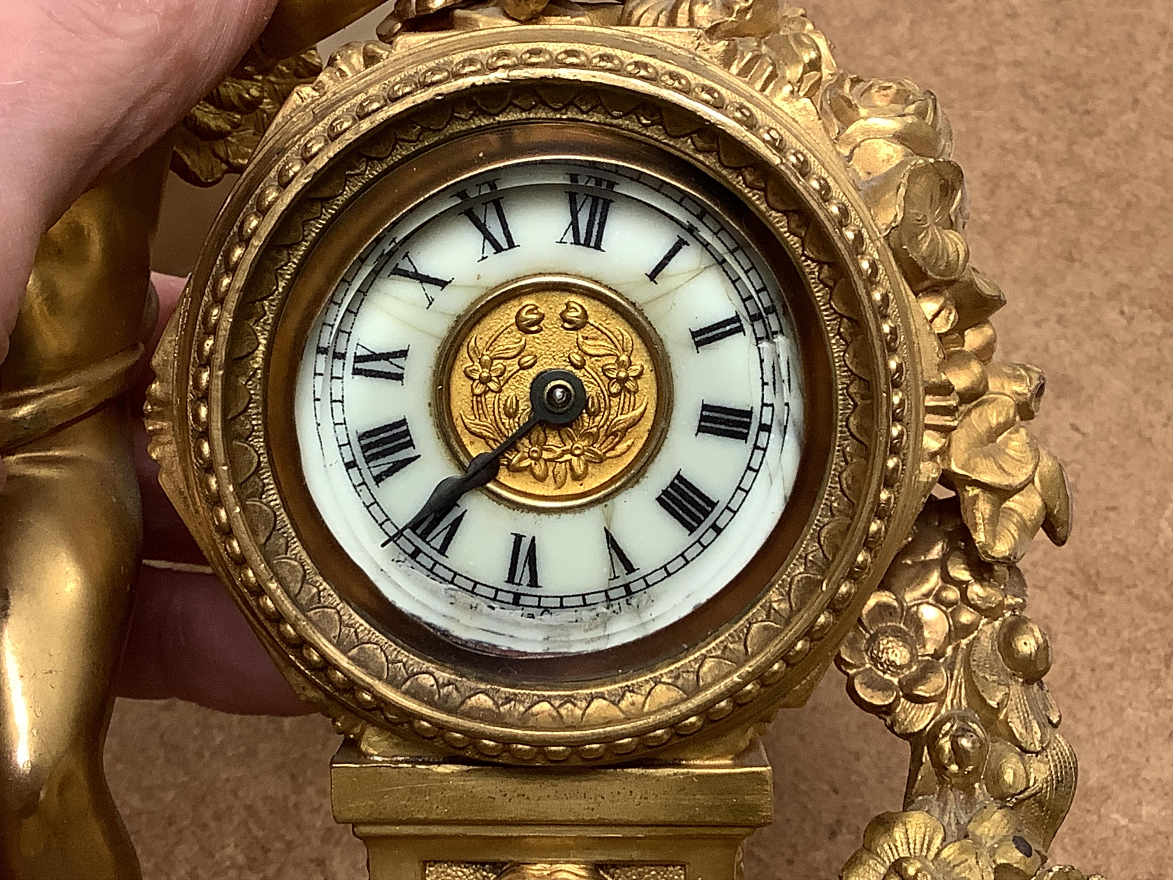 A late 19th century gilt metal cherub timepiece, Ansonia clock company movement, 21cm high